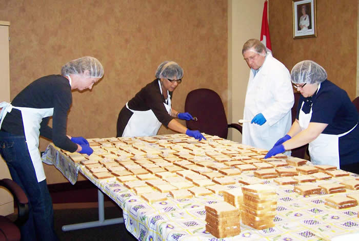 Photo of some of our Canadian Food Inspection Agency staff preparing sandwiches for Hope Cottage residents